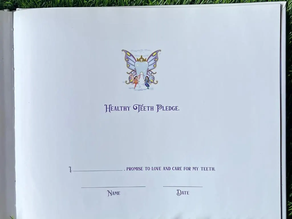Healthy Teeth Pledge page from The Adventures of the Tooth Fairy children's book, with a fillable name and date for kids to sign